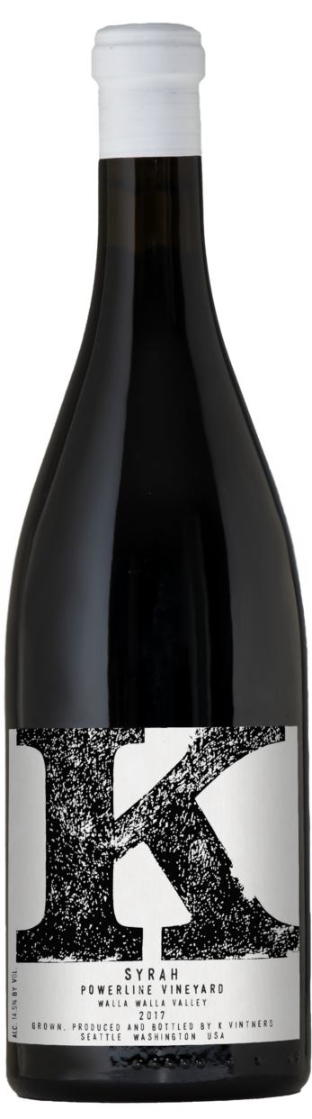 A dark tall bottle of wine with white capsule on top and white label with black text, red wine inside.