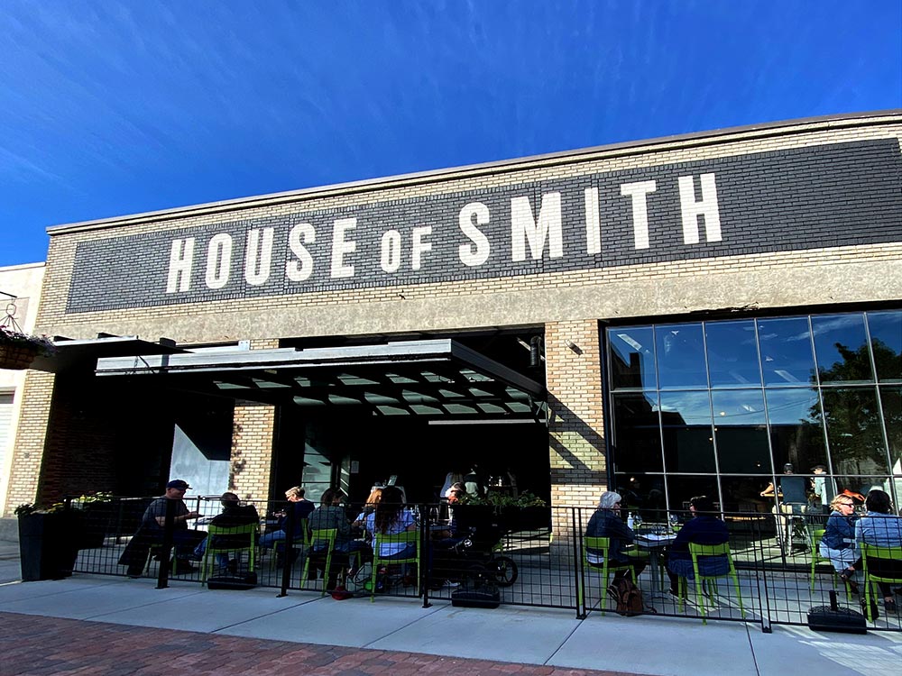 Out front at House of Smith Walla Walla. People are enjoying wine in the sun.